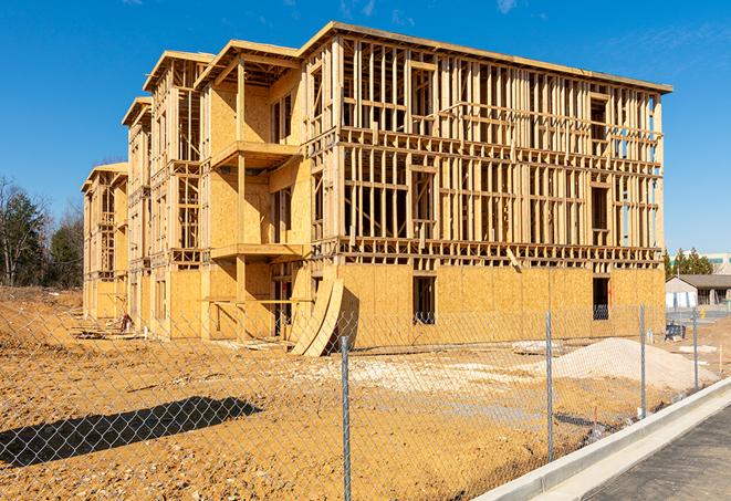 a temporary chain link fence in front of a building under construction, ensuring public safety in Wylie